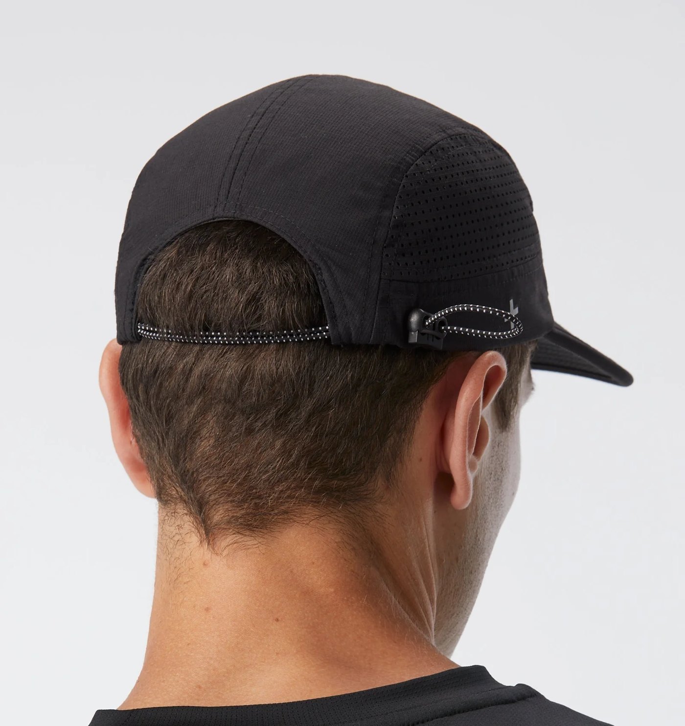 Back of the five panel cap showing perforated side panels and reflective bungee toggle