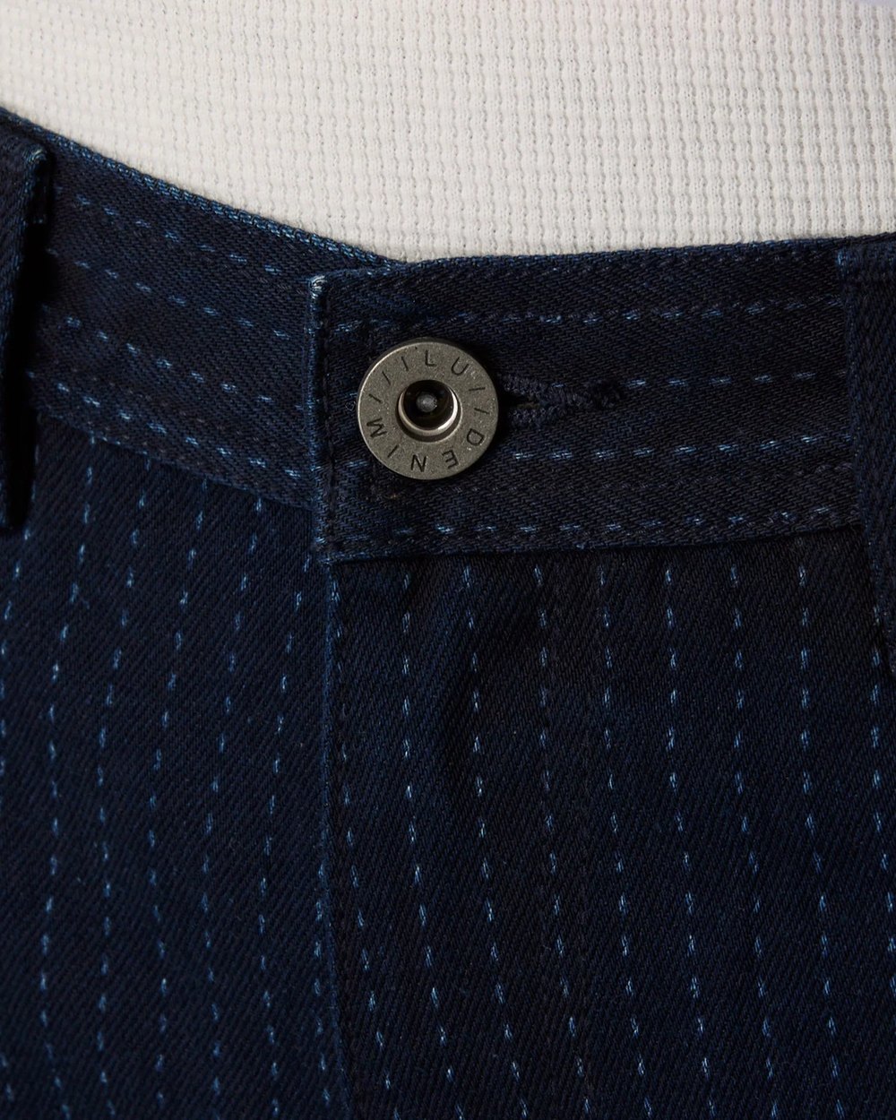 Close up of the pinstripe denim waistband and ILU Denim shank button