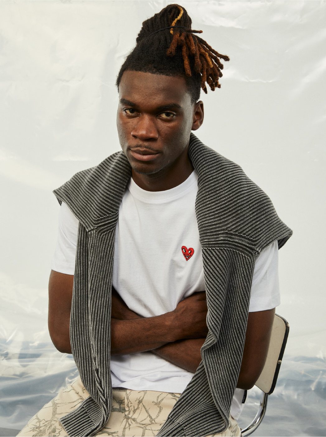 I Love Ugly x Keith Haring: White heart tee with a knit tied over the shoulders