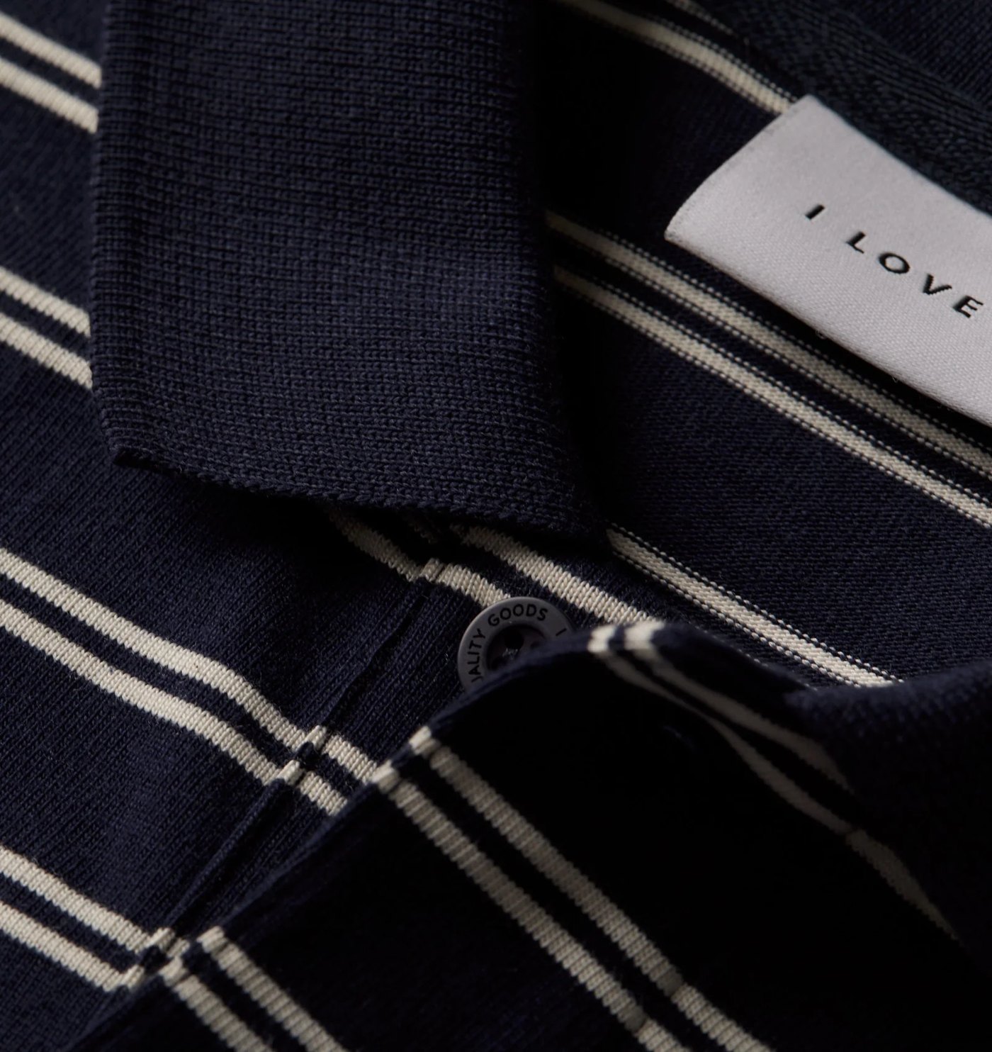 Close-up of the polo knit collar, placket and engraved button