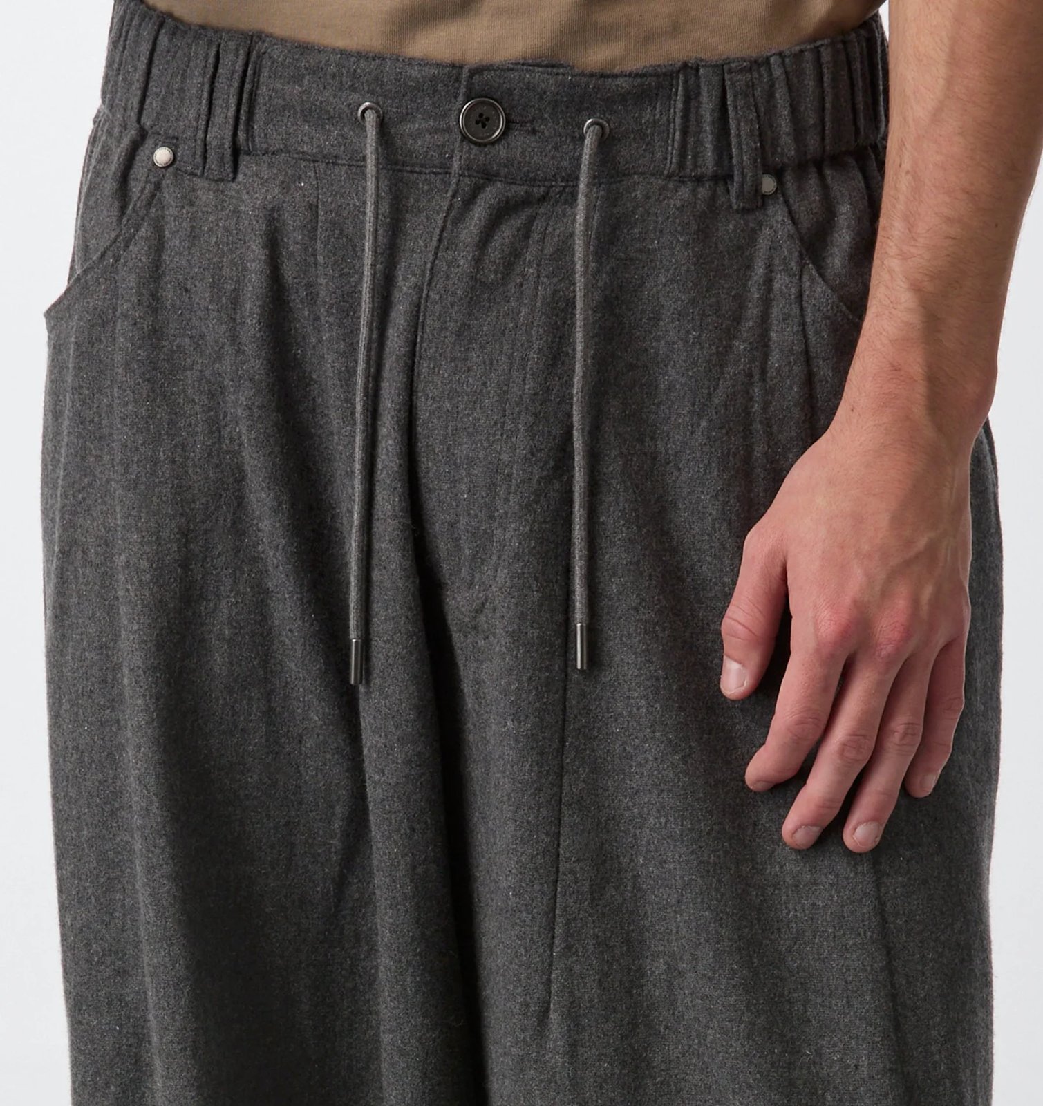 Close-up of the HD Pant waistband with drawcord, button and pleats