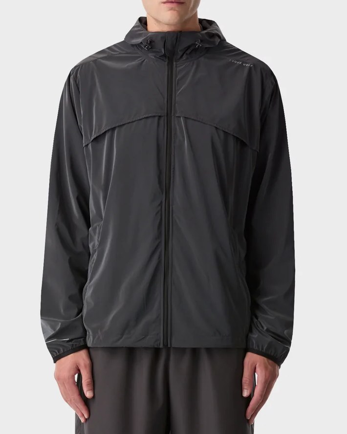 The same windbreaker in natural light, showing a charcoal finish