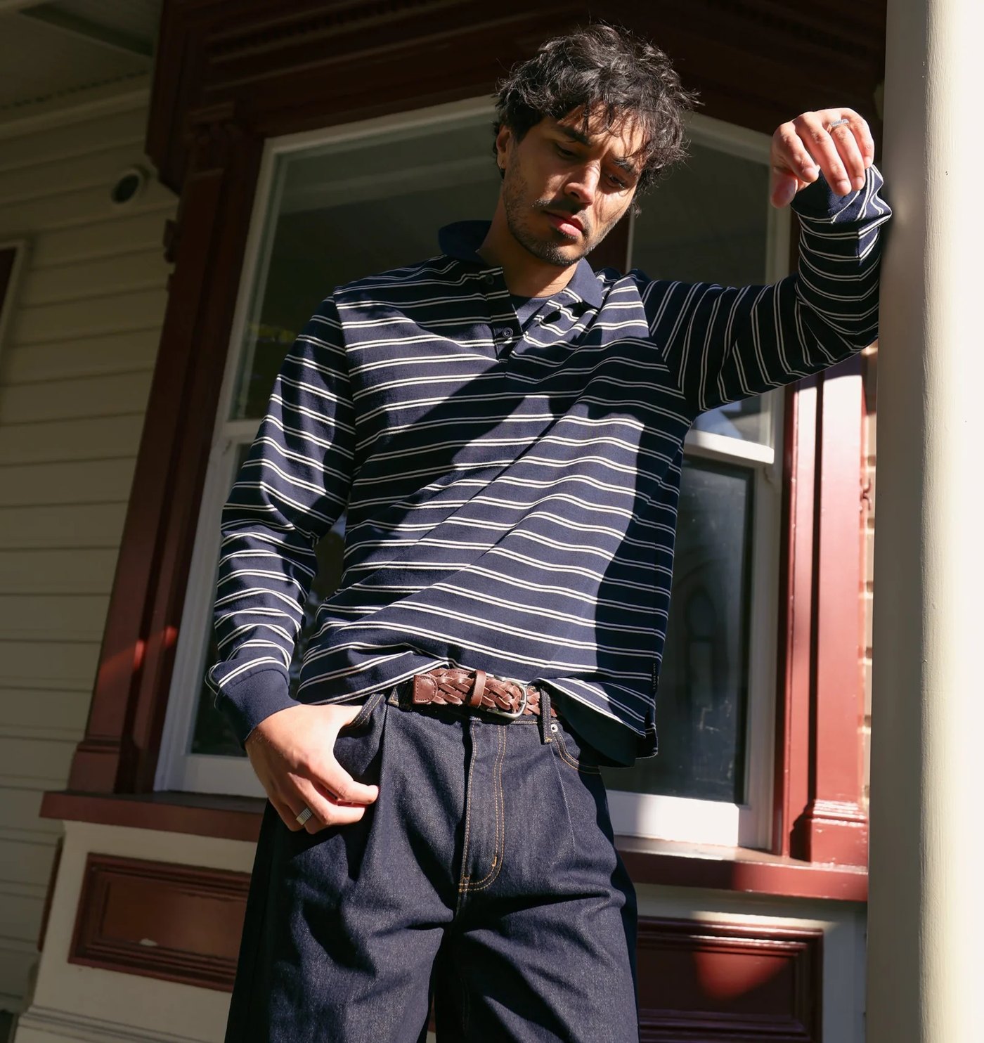 Navy and cream striped long sleeve polo worn with raw denim