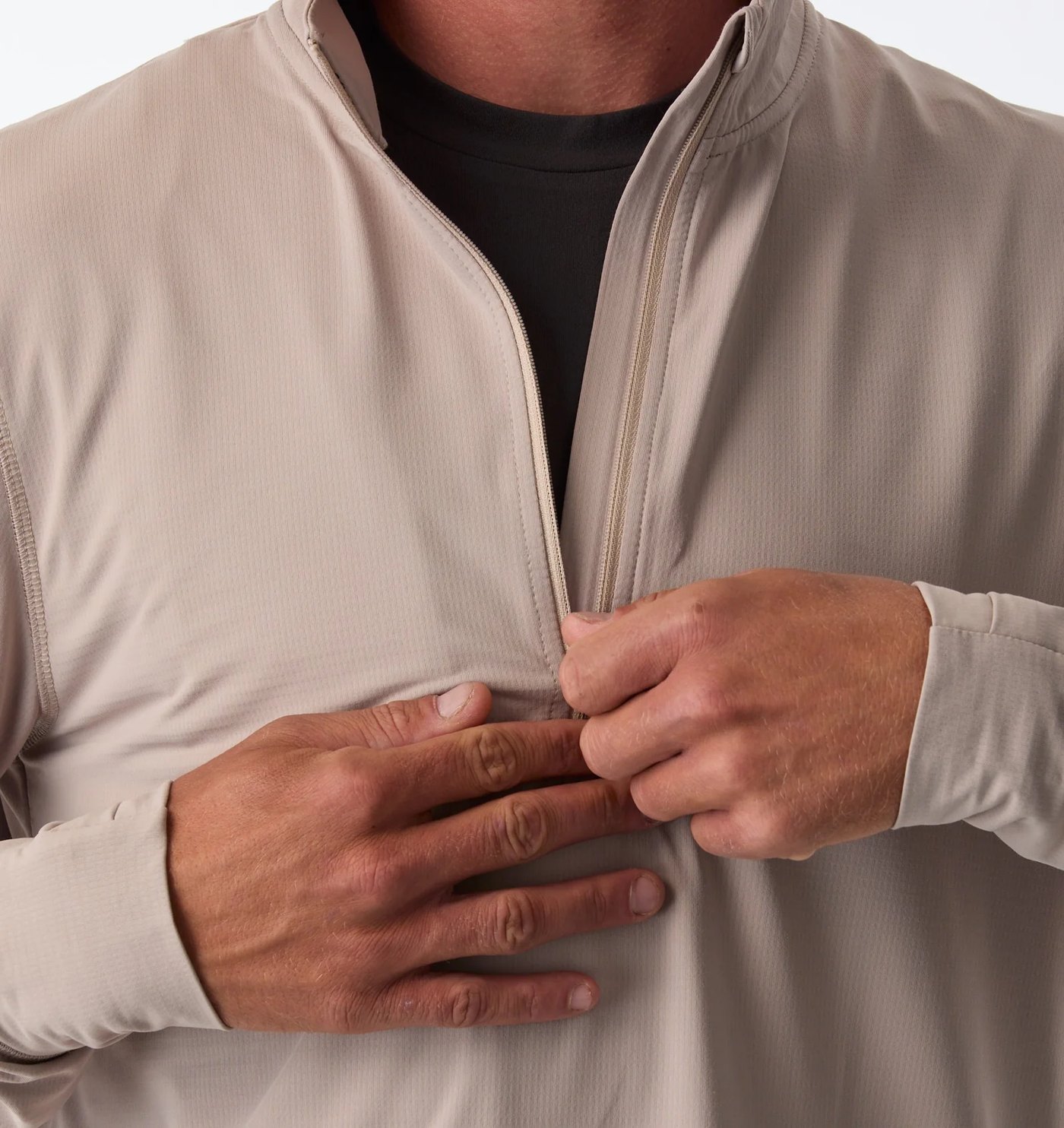 Close-up of the half zip opening and grid-textured fabric