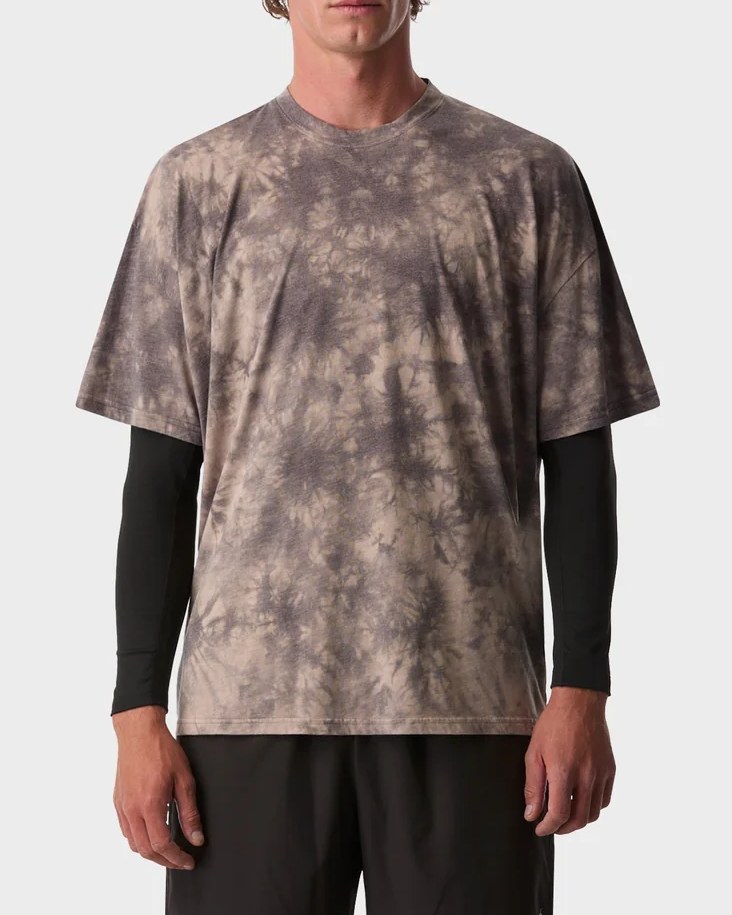 Grey and sand tie dye active tee layered over a black long sleeve base layer