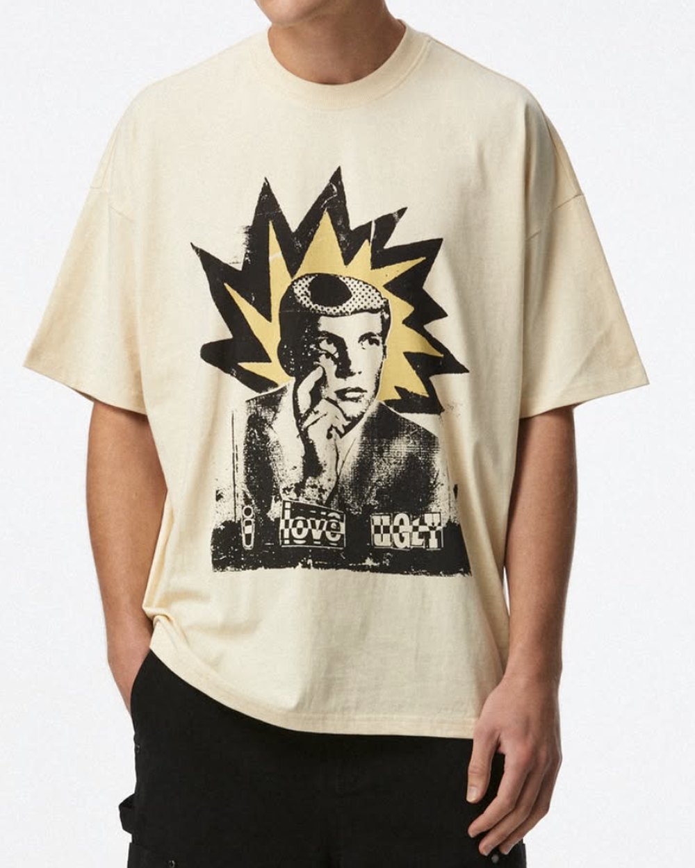 Cream oversized tee with a distressed starburst portrait graphic
