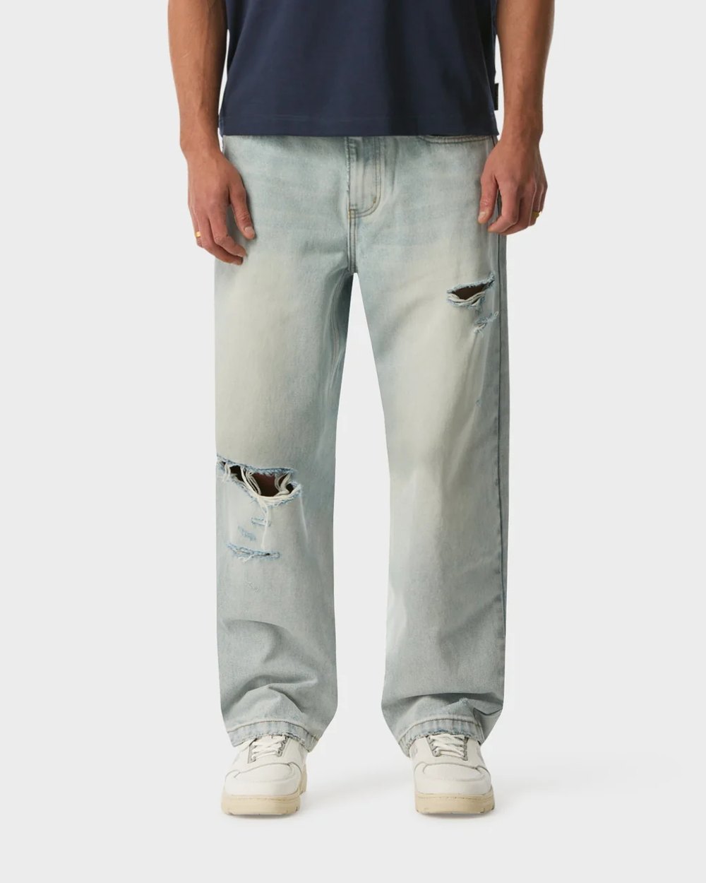 Bleached light wash distressed wide leg jeans with ripped knee