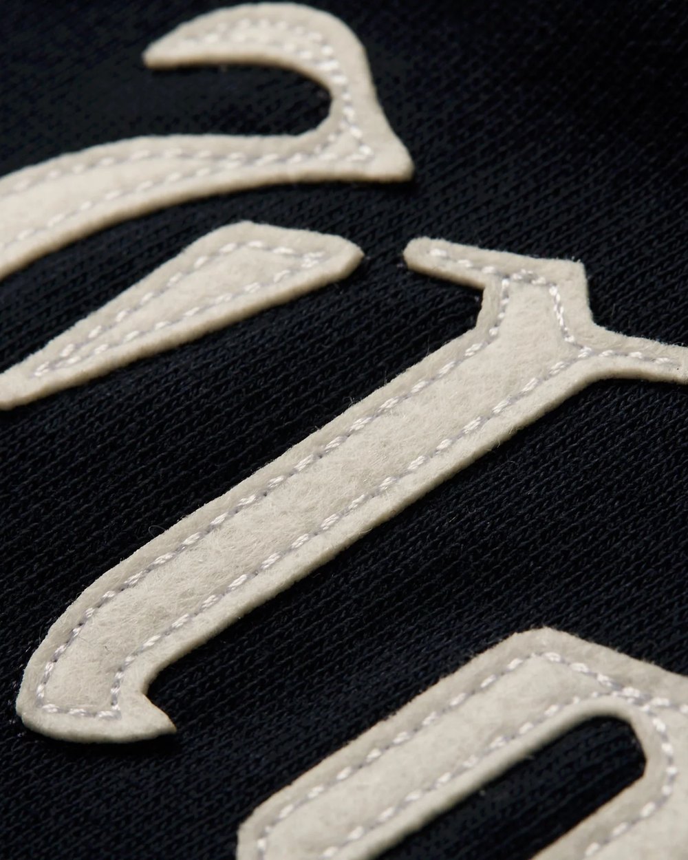 Close up of the stitched felt Ugly Love lettering