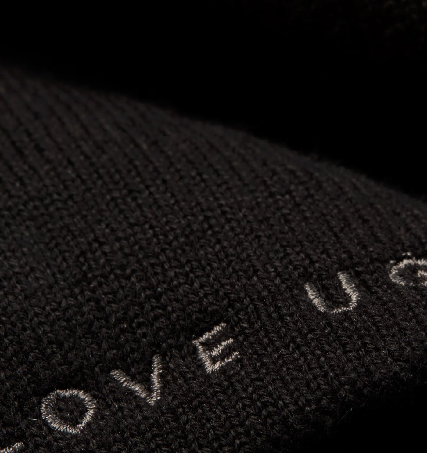 Close-up of the fine knit and grey embroidered wordmark
