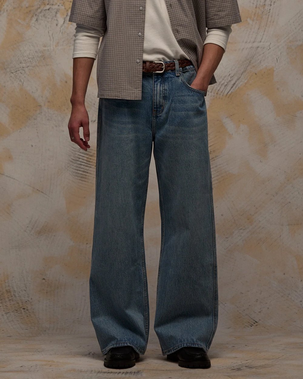 Mid wash wide leg bootcut jeans with braided brown belt
