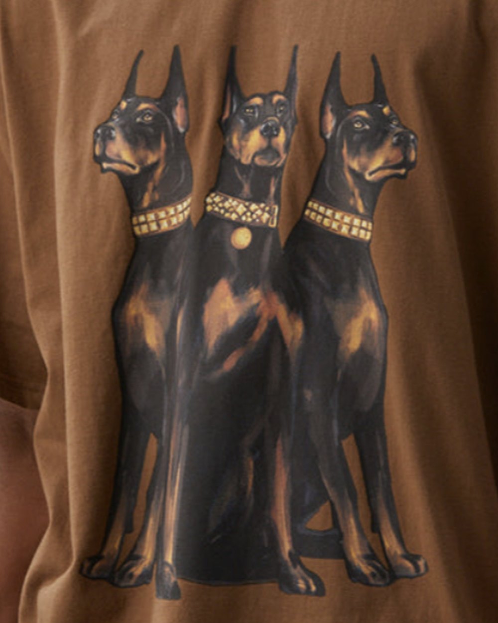 Close up of the painted Doberman print with studded gold collars