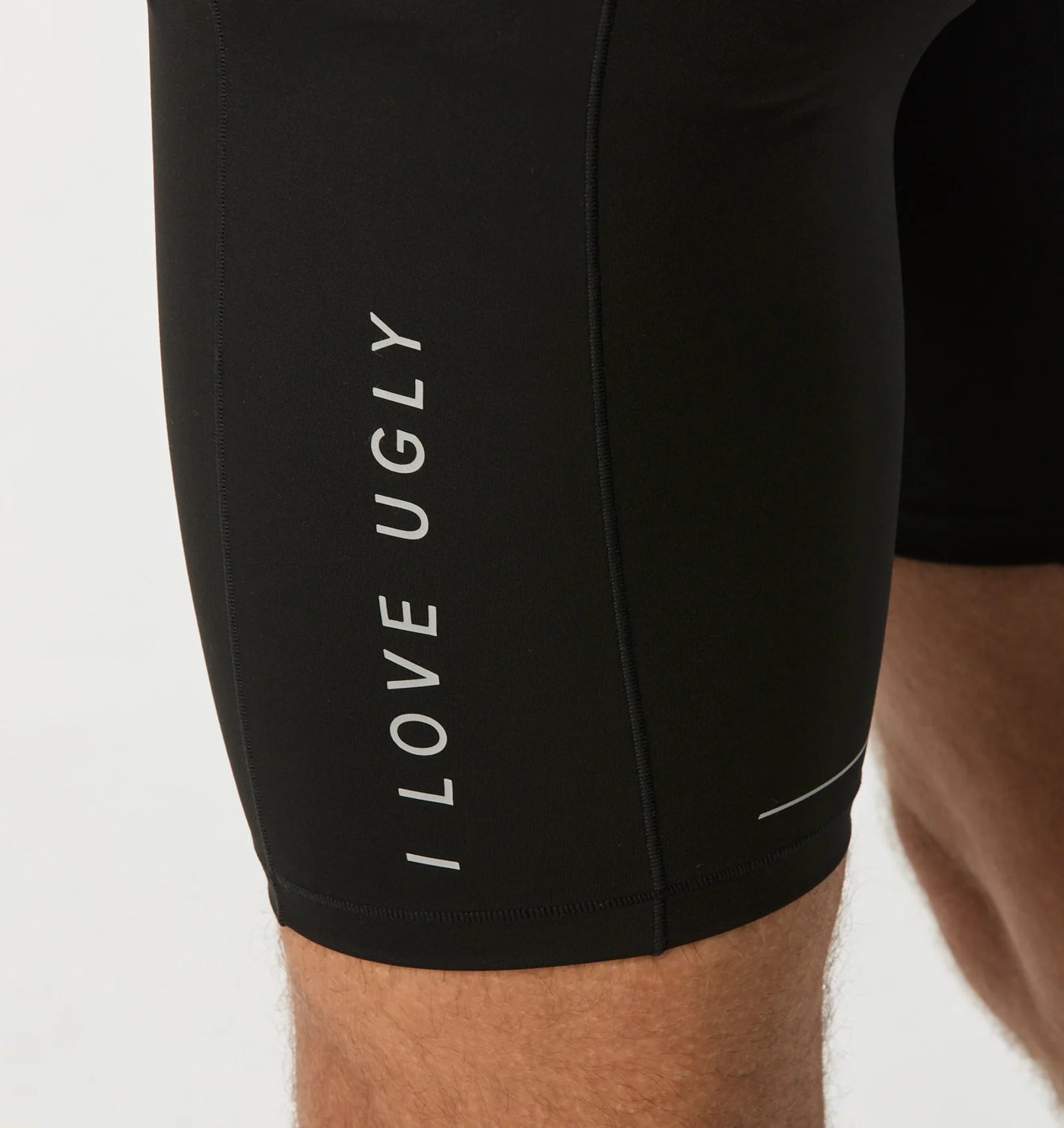 Close-up of the reflective vertical wordmark and panel seams on the thigh