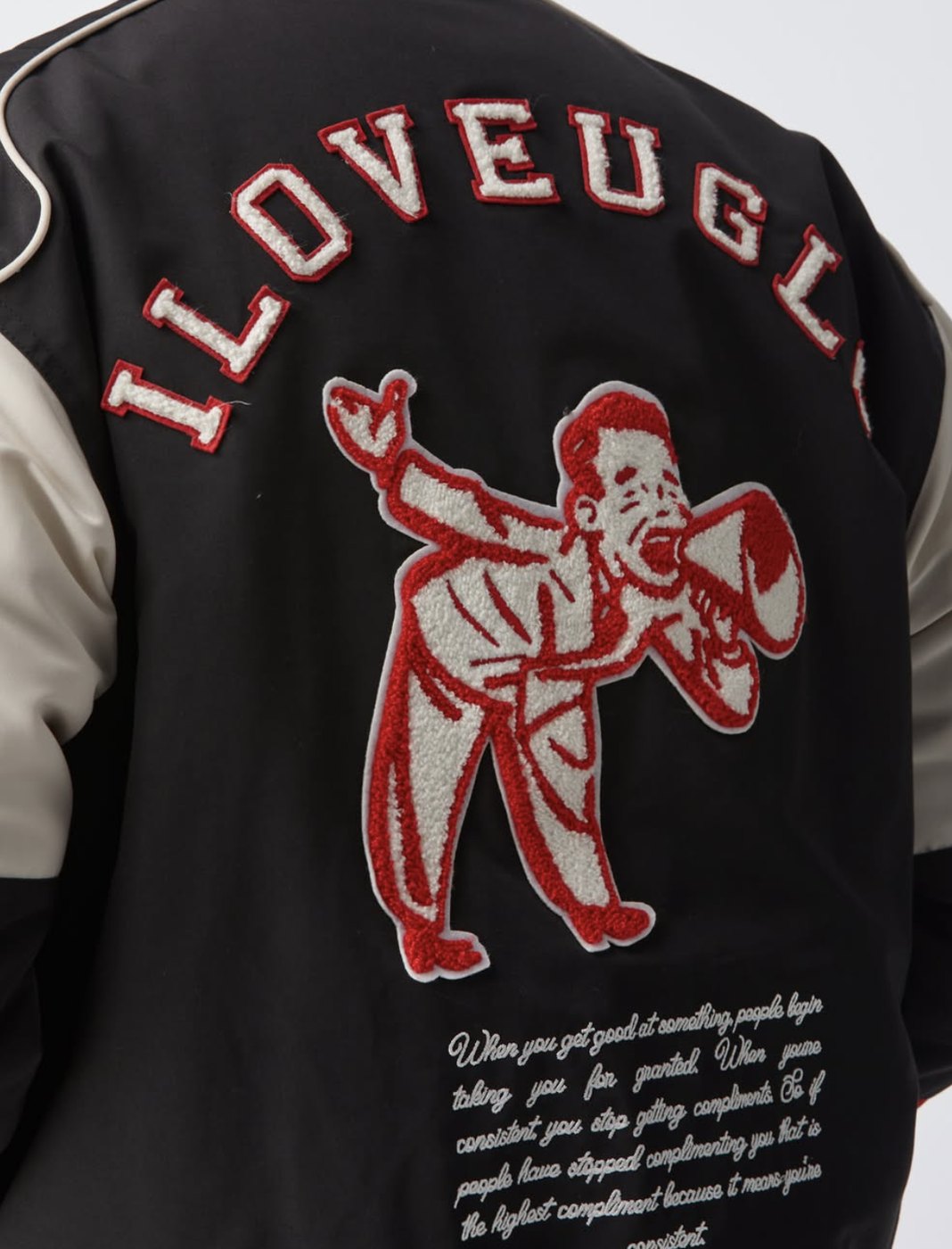 Close up of the chenille I Love Ugly megaphone patch on the racing jacket back