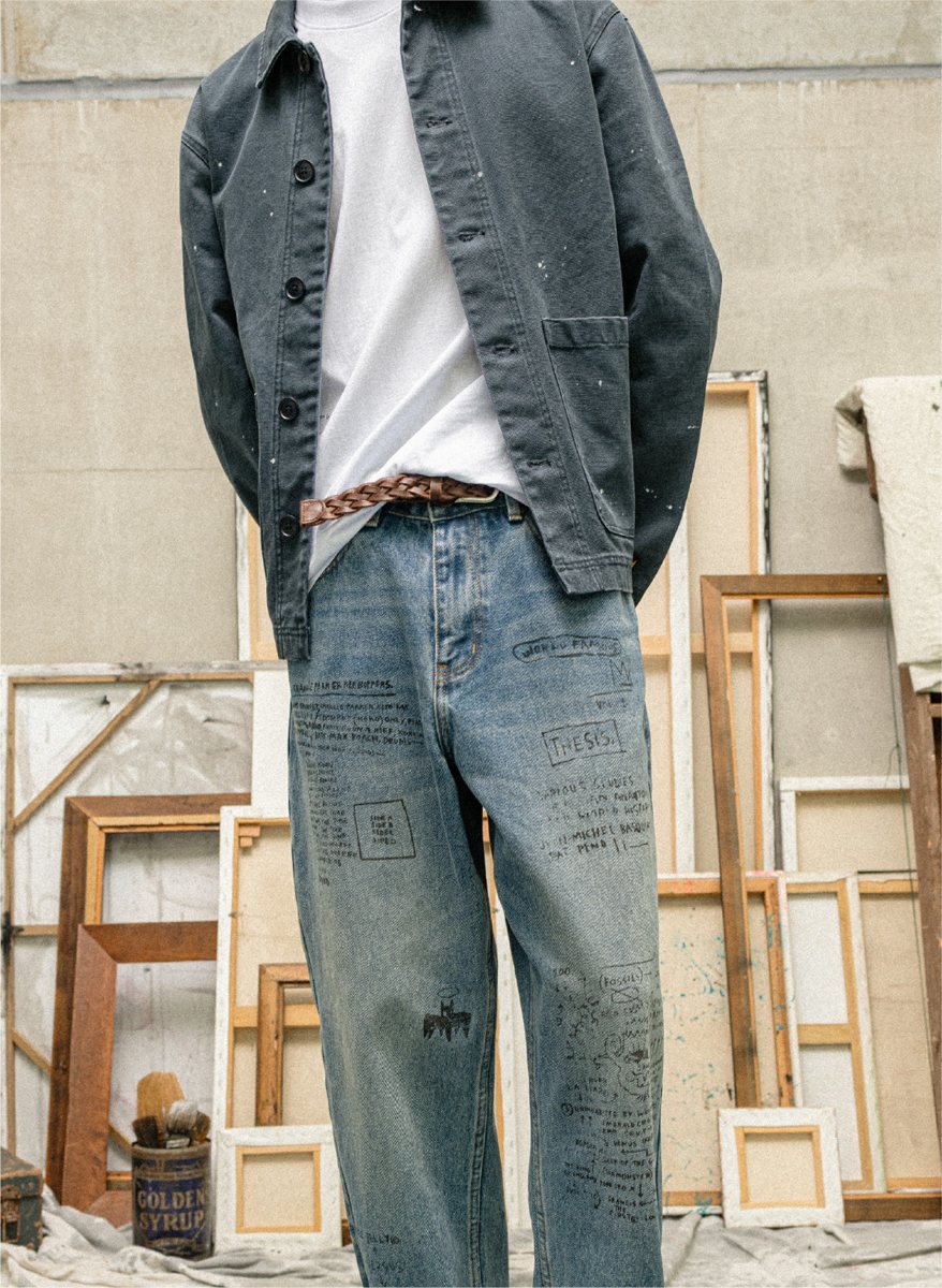 I Love Ugly x Jean-Michel Basquiat: Paint-splattered chore jacket over Basquiat script-print jeans