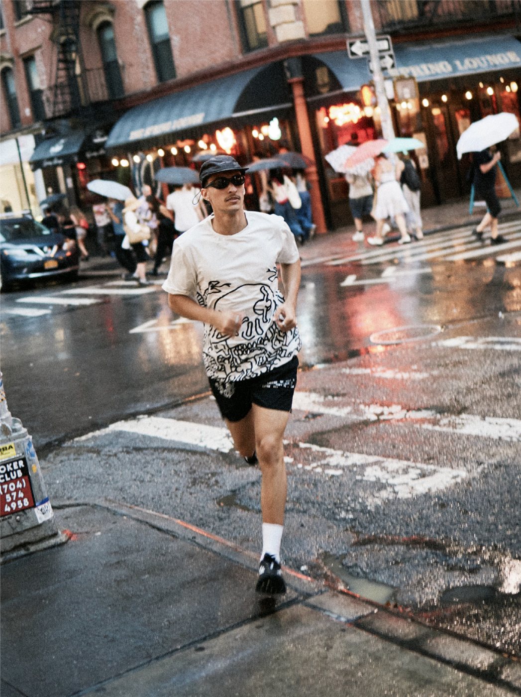 I Love Ugly x Keith Haring: Running in the rain in a printed tee and shorts