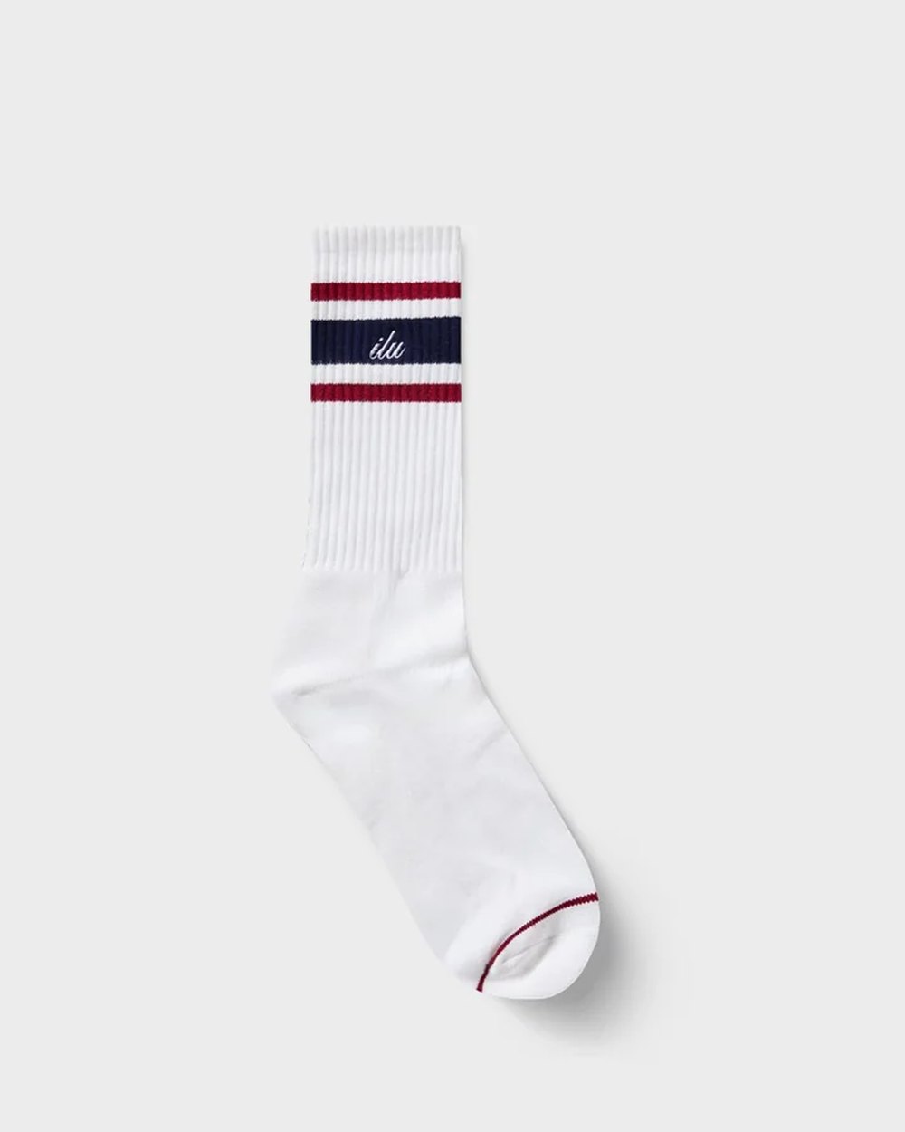 White ribbed crew sock with navy and red stripes