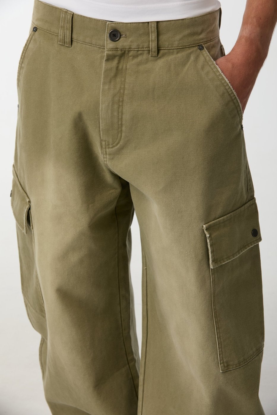 Close-up of the Balloon Cargo Pant canvas, button fly and flap cargo pockets