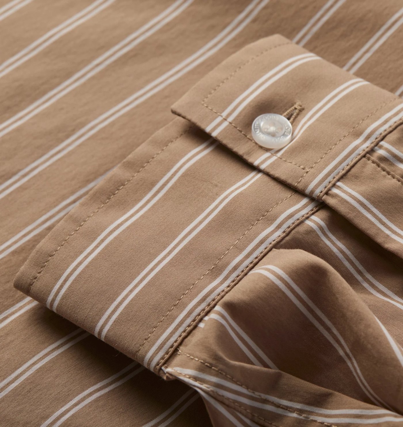 Close-up of the striped cuff and engraved button