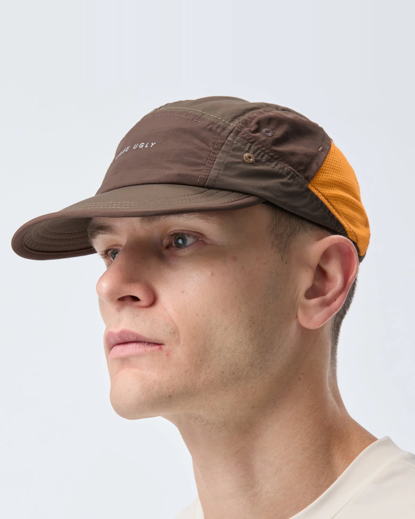 Brown nylon panelled running cap with orange mesh side panels