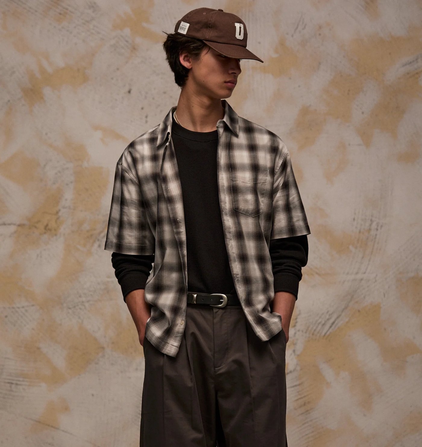 Short sleeve shadow plaid shirt worn open over a black long sleeve top