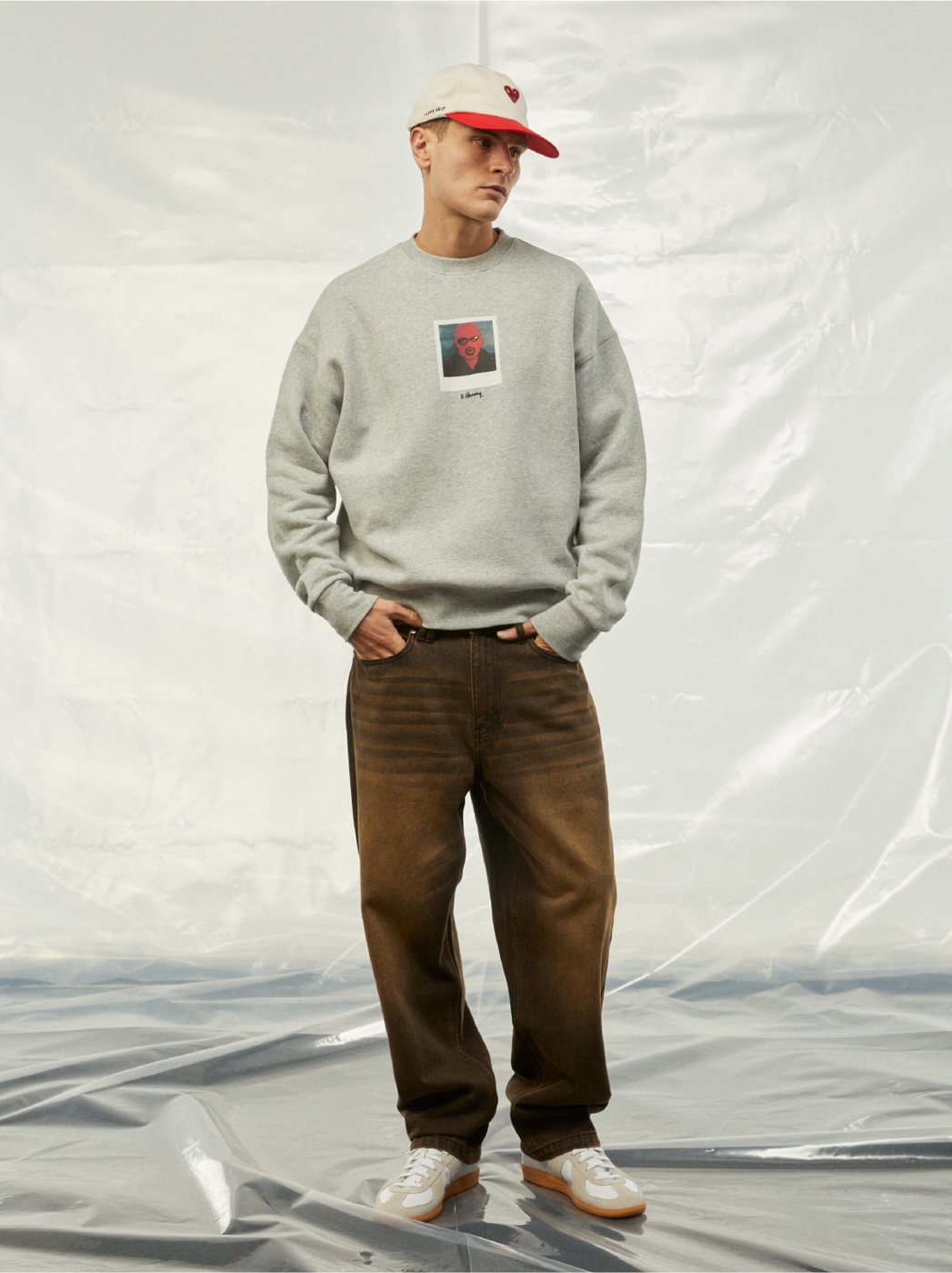I Love Ugly x Keith Haring: Grey polaroid crewneck with brown pants and cap