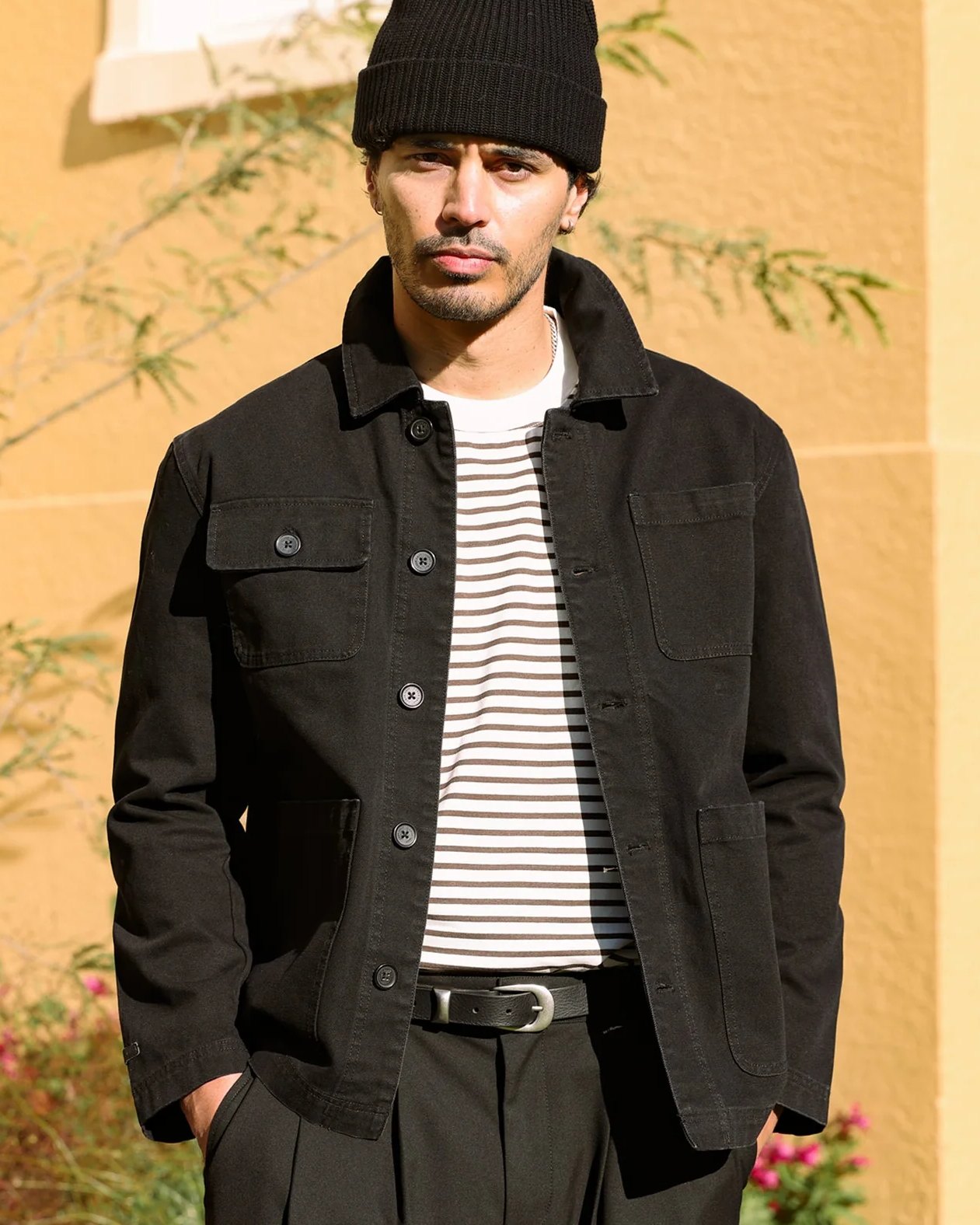 Black cotton canvas Chore Jacket worn open over a striped tee
