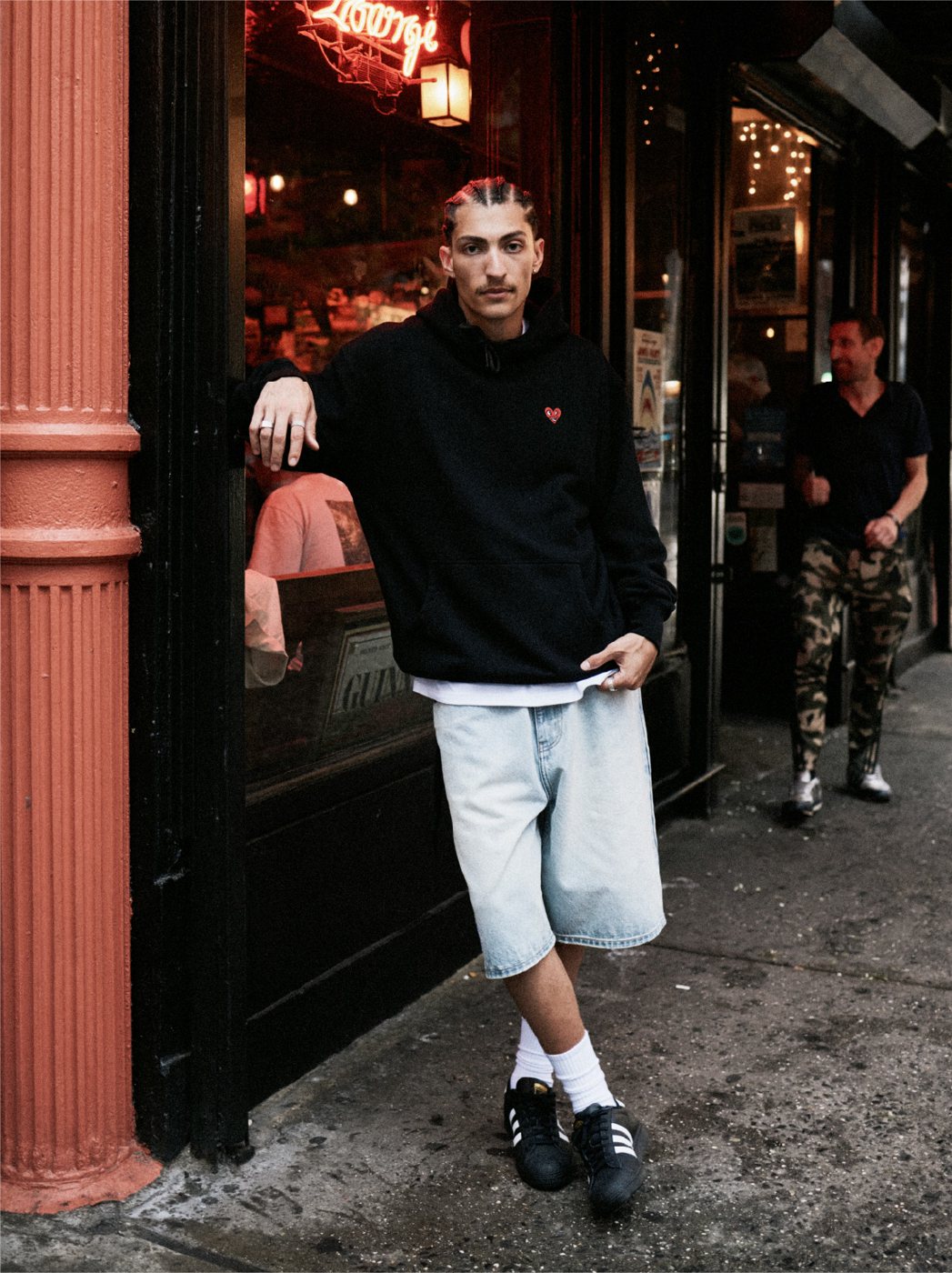 I Love Ugly x Keith Haring: Black crewneck in a bar doorway