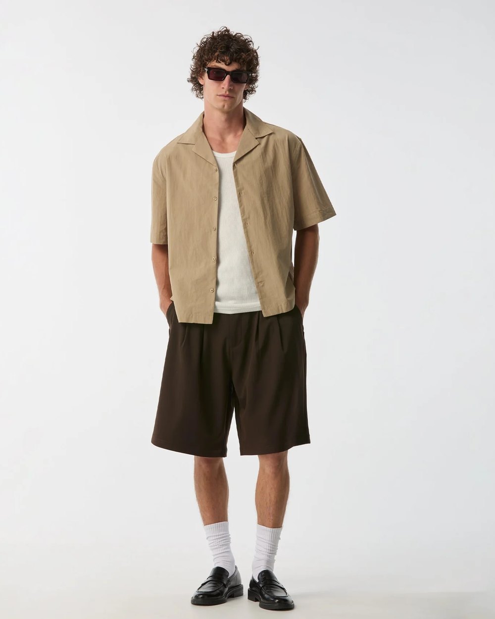 Alby pleat short styled with a camp collar shirt, white socks and loafers
