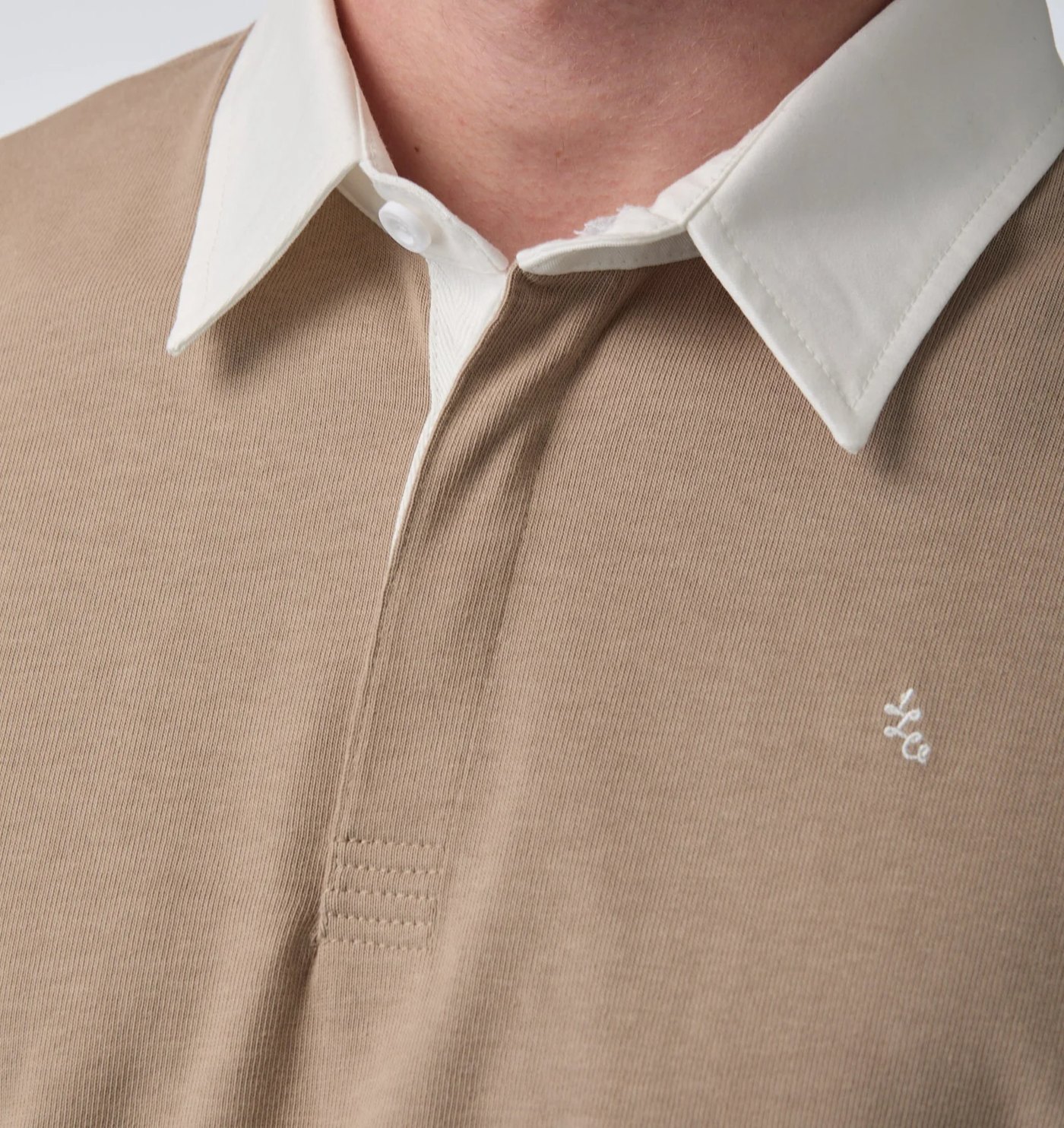Close-up of the rugby polo contrast collar, placket bartack and embroidered monogram