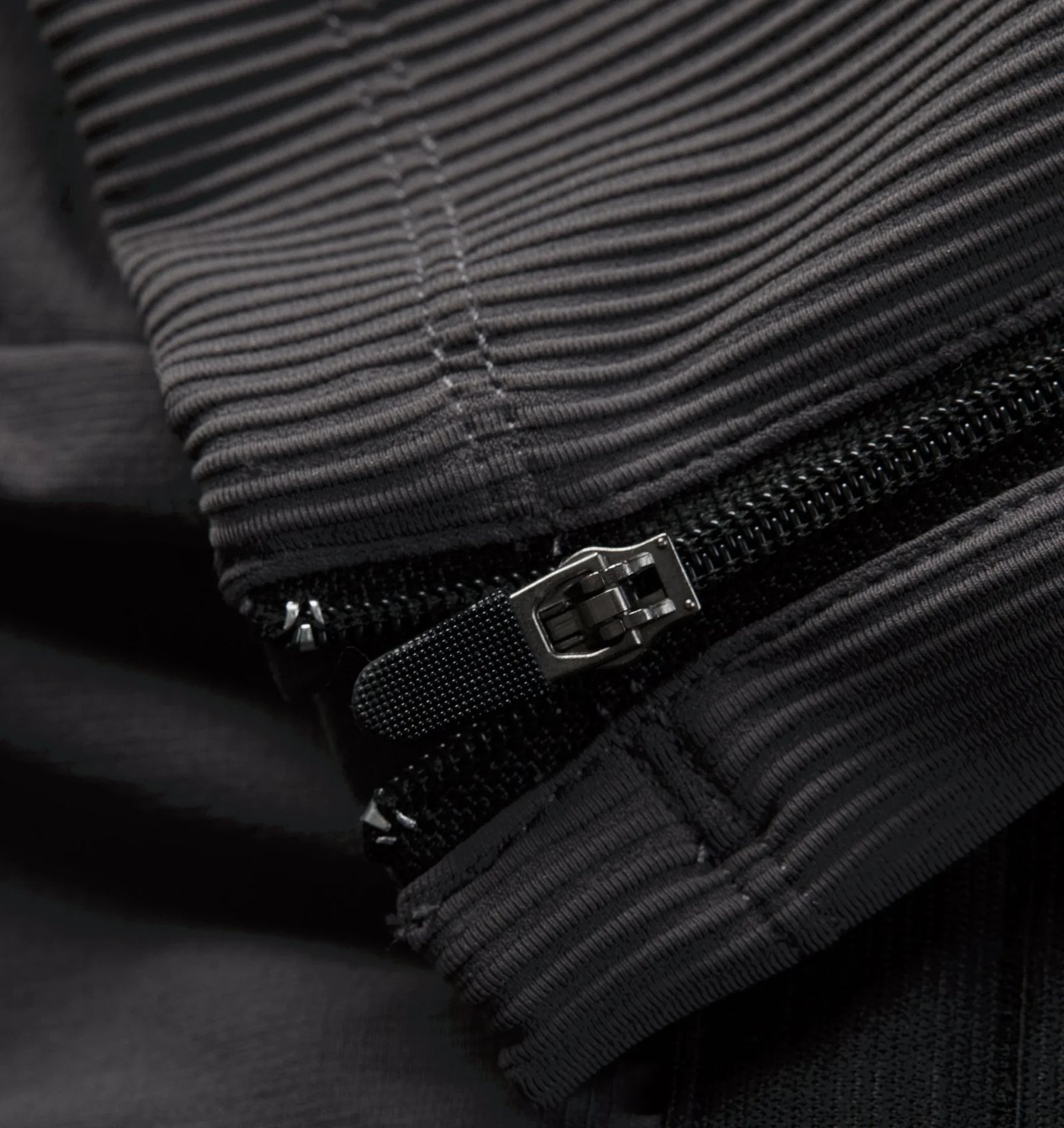 Close-up of the ribbed panel and ankle zip