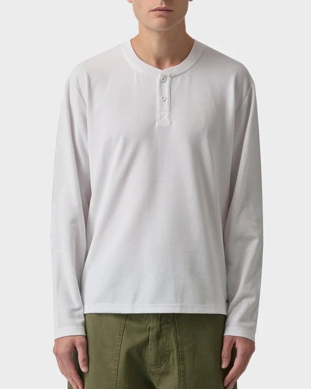White waffle knit long sleeve henley worn with olive fatigue pants