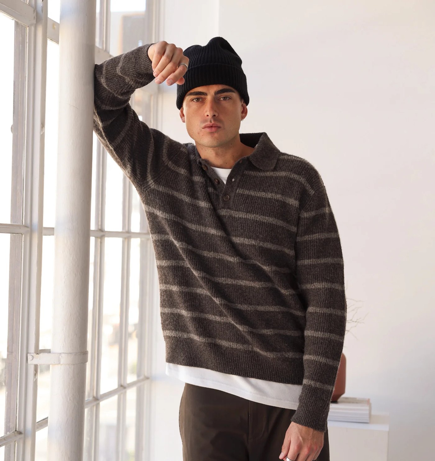 Brown striped brushed knit polo pullover worn by a window