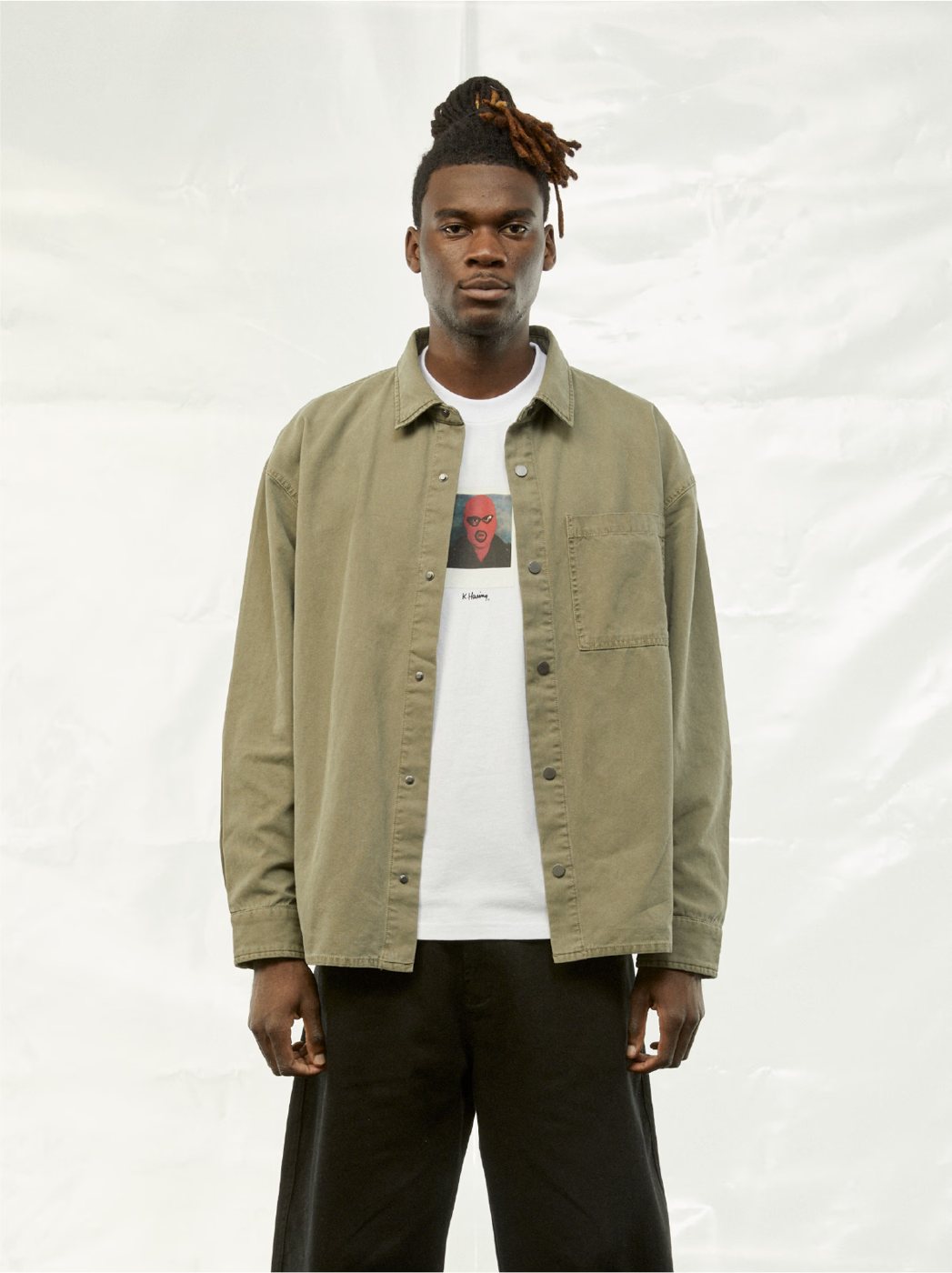 I Love Ugly x Keith Haring: Olive overshirt over a white graphic tee