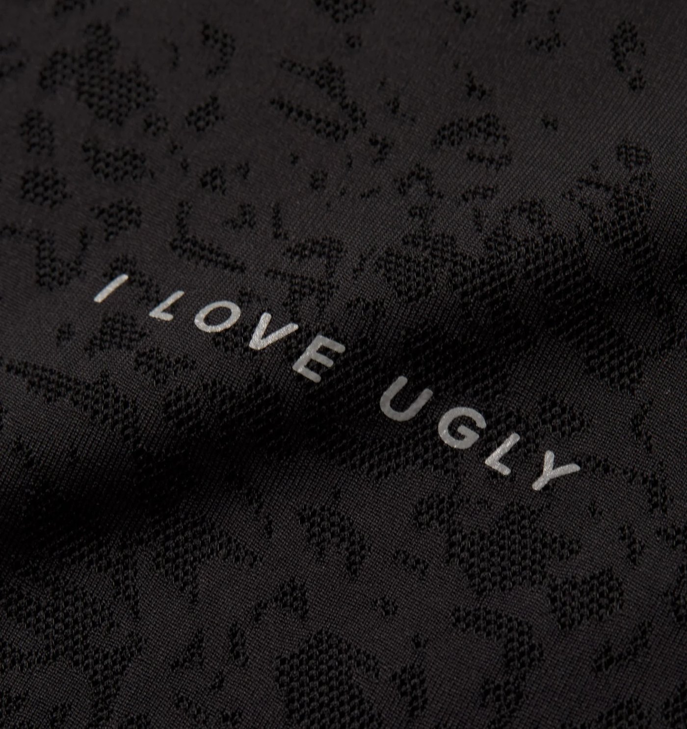 Close-up of the lace jacquard knit and reflective wordmark