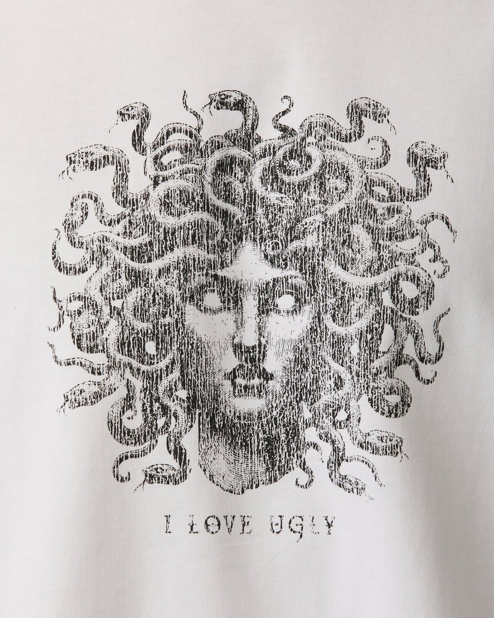 Close up of the distressed Medusa print and I Love Ugly wordmark