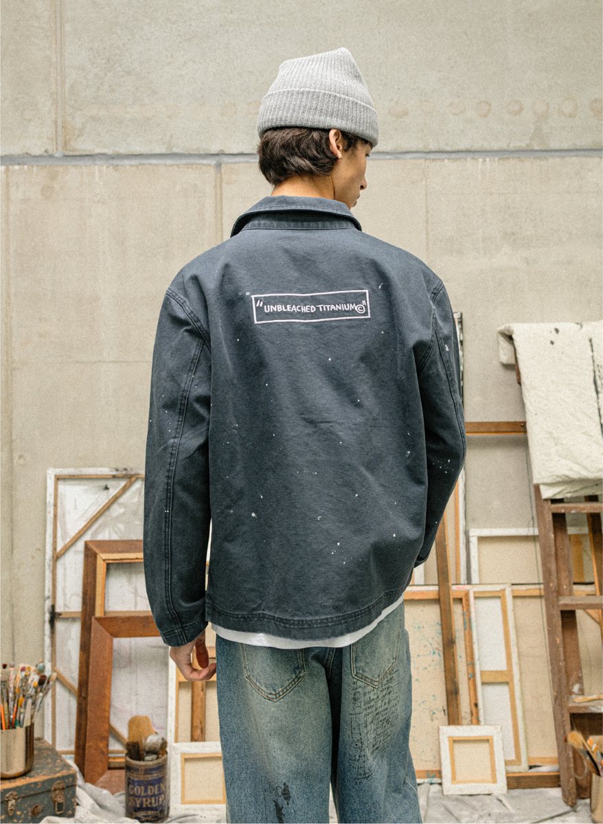 I Love Ugly x Jean-Michel Basquiat: Back of the washed chore jacket with UNBLEACHED TITANIUM embroidery