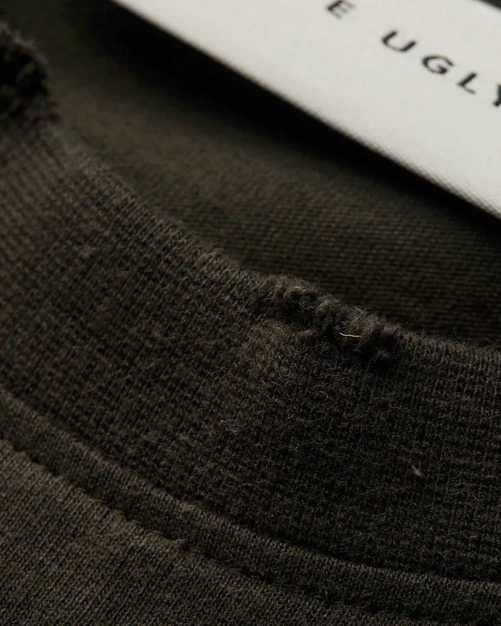 Close up of the distressed neckline and woven label