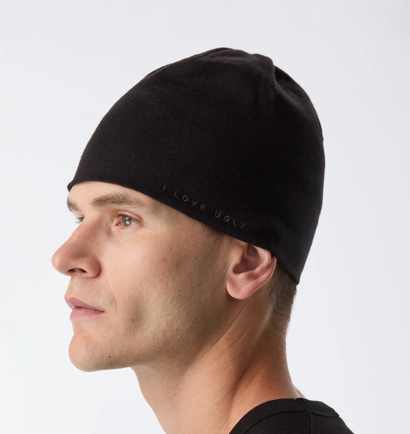 Black fine-knit skull beanie with tonal embroidered wordmark