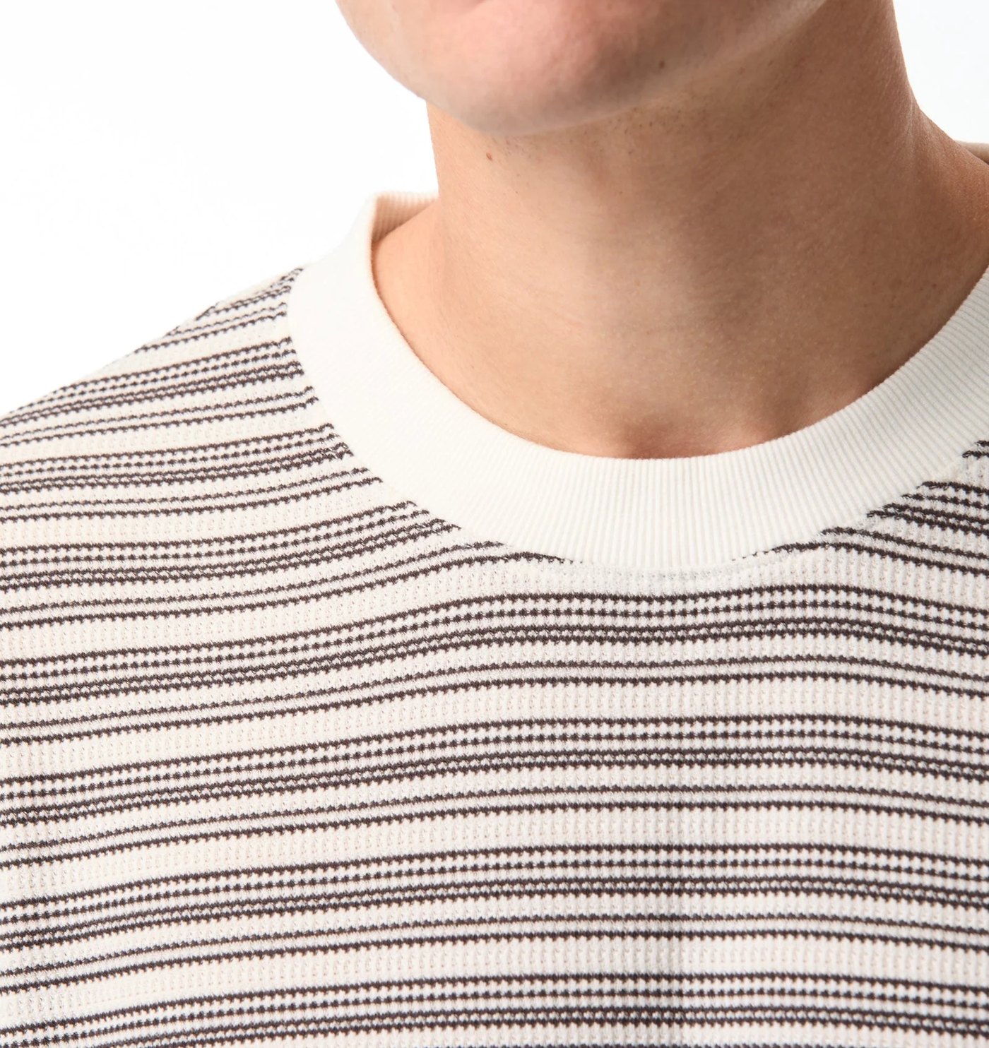 Close-up of the striped waffle texture and ribbed ecru neck