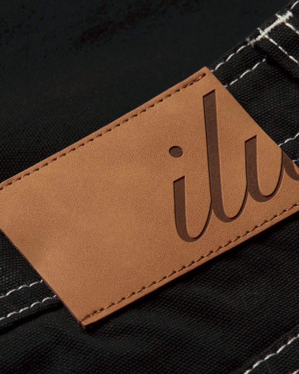 Close up of the debossed leather ILU back patch and contrast stitching