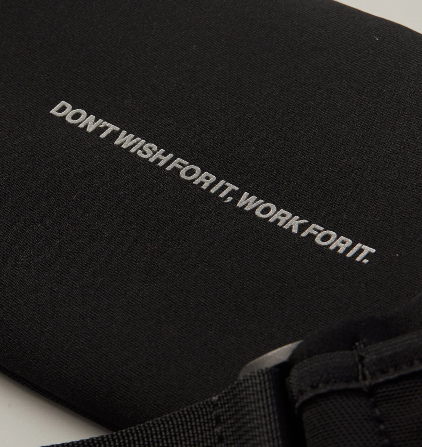 Close-up of the reflective Don't Wish For It, Work For It print on the neoprene