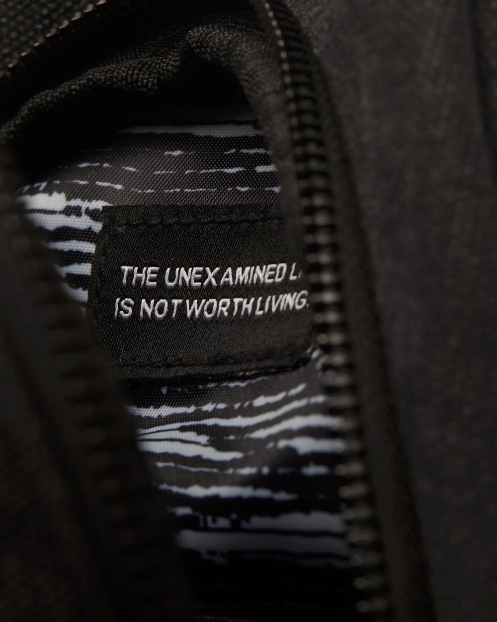 Inside the sling bag showing the printed lining and quote label