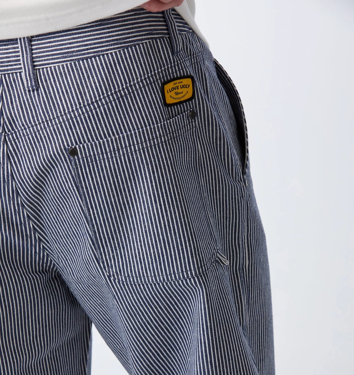 Close-up of the back pocket with yellow woven badge and rivets