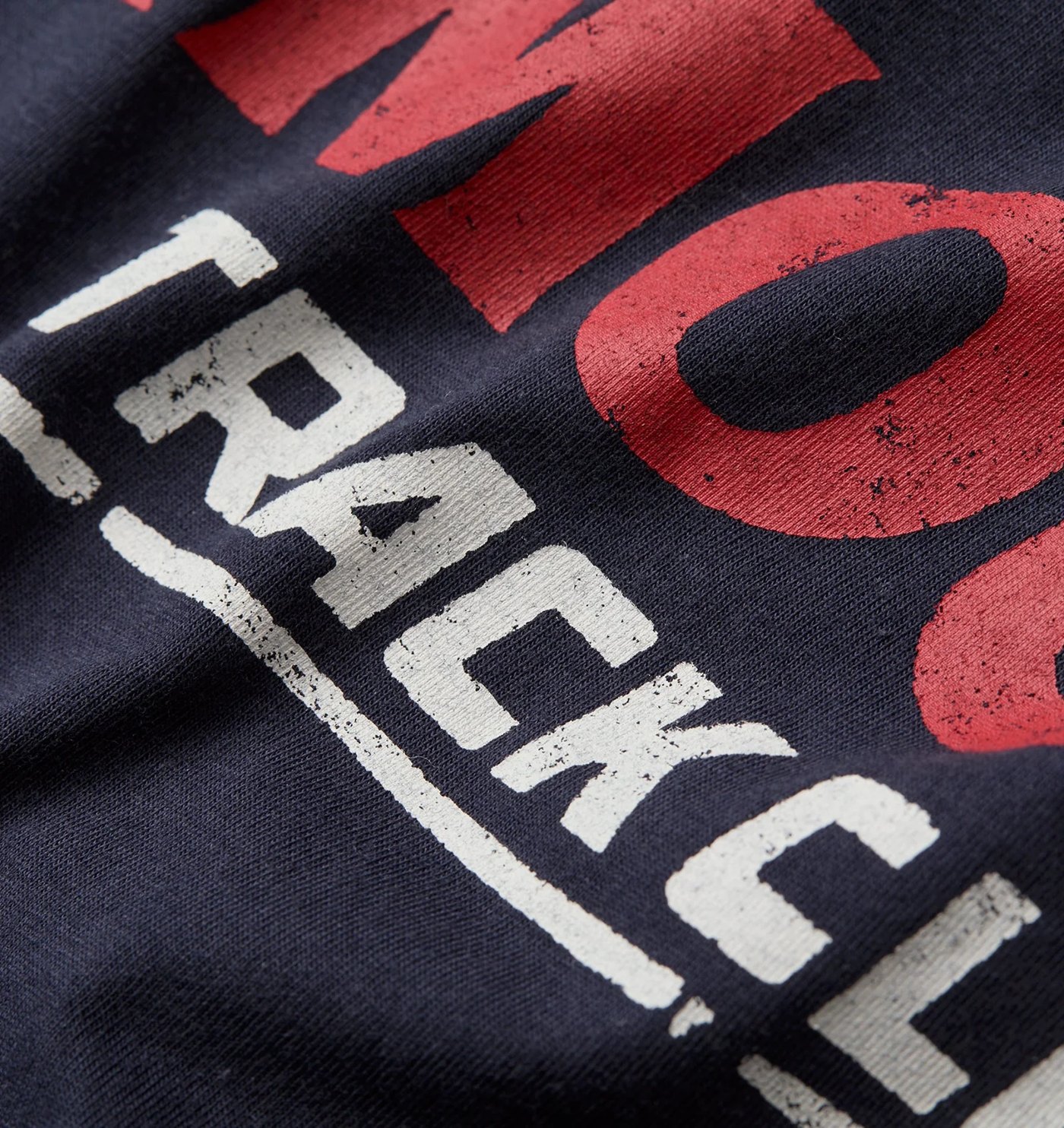 Close-up of the distressed Amour Track Club lettering