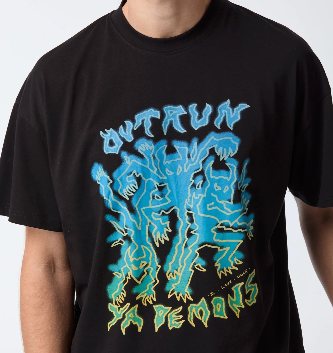 Black tee with blue and green Outrun Ya Demons graphic