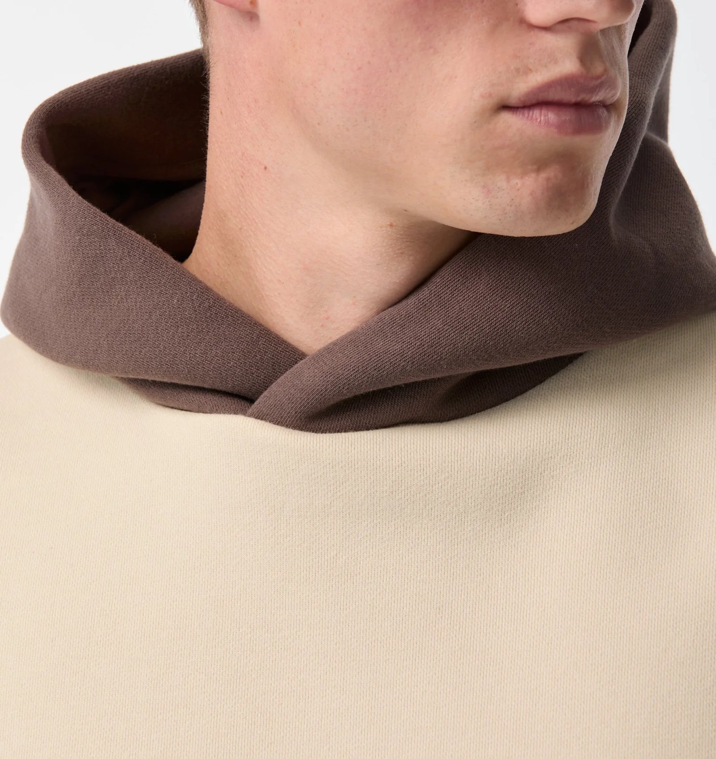 Close-up of the contrast brown crossover hood on the cream body