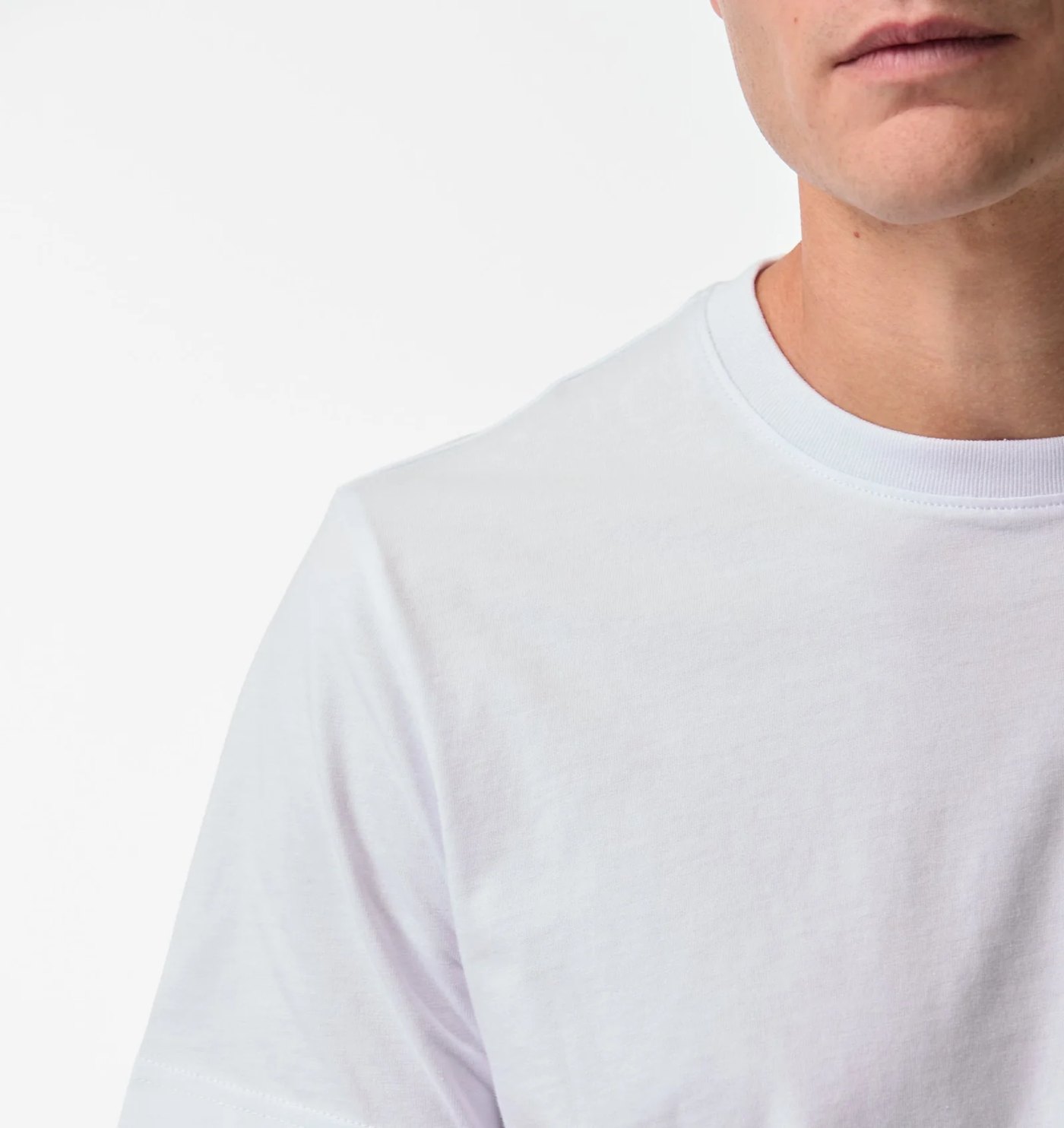 Close-up of the ribbed crew neck and shoulder seam