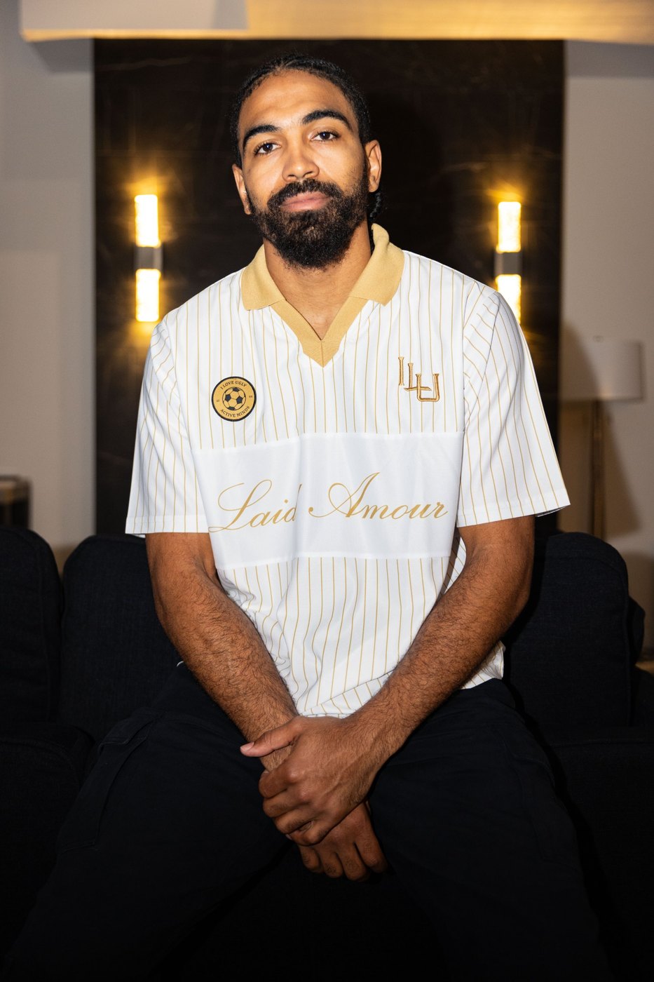 Model in the white and gold pinstripe Laid Amour football jersey