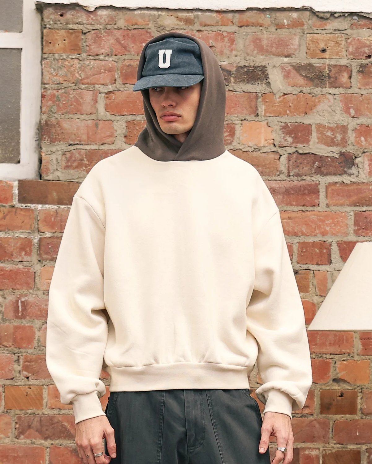 Cream heavyweight cropped hoodie with contrast brown hood, worn hood up