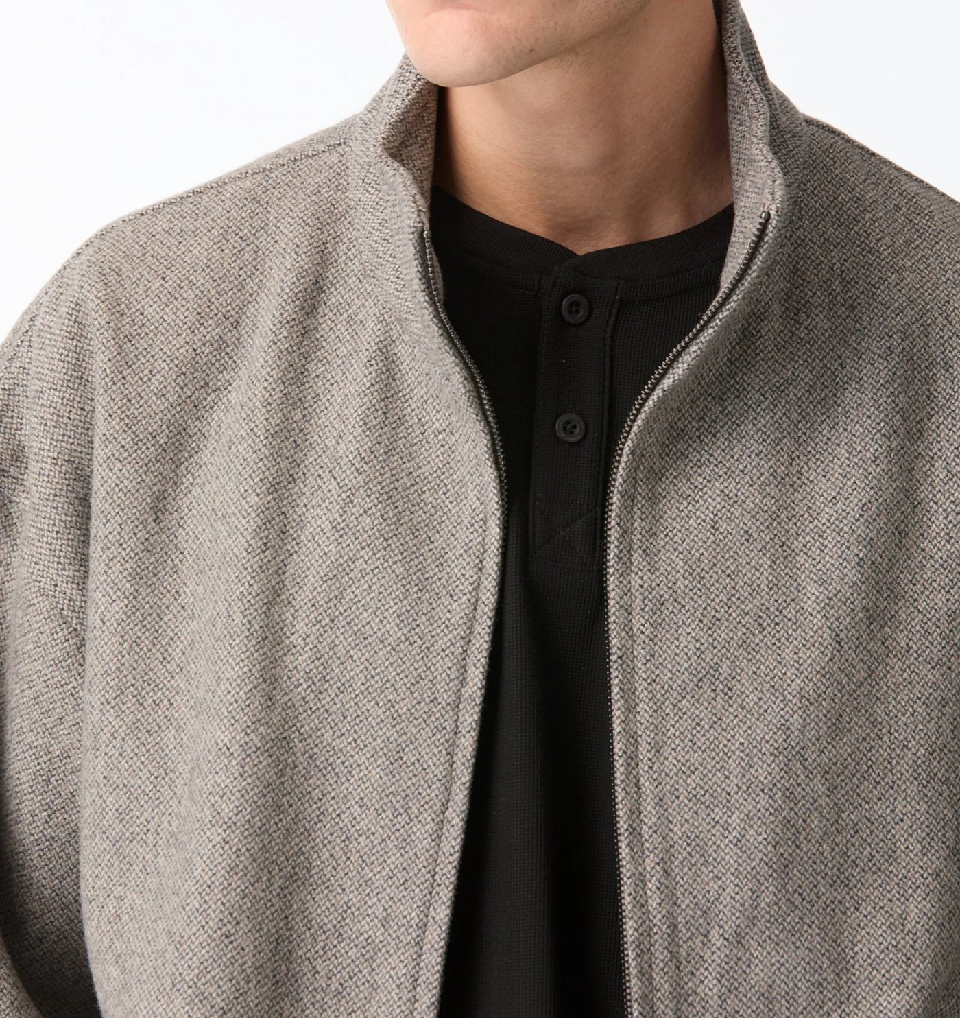 Close-up of the wool blend funnel neck and zip worn over a black henley